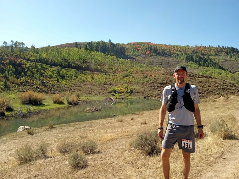 click to enlarge - photo by: Brandon Moore - Quick photo by the beaver pond! Heading towards Temple Fork aid station. Way to go Tom!